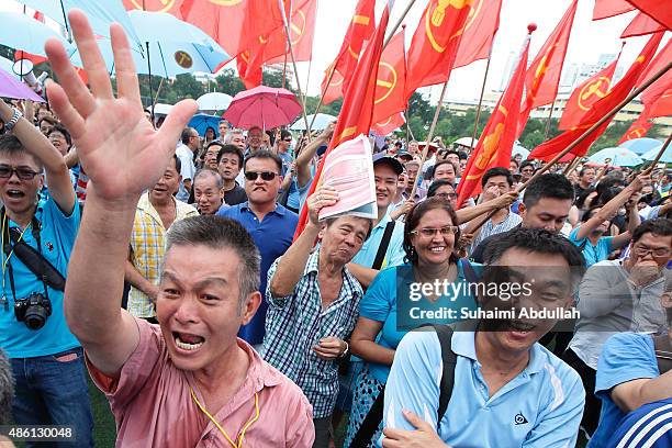 Worker's Party supporters react to their candidate speech after nomination is closed at Raffles Institution on September 1, 2015 in Singapore....