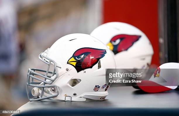 Arizona Cardinals helmets sit on the sideline against the Oakland Raiders at O.co Coliseum on August 30, 2015 in Oakland, California.