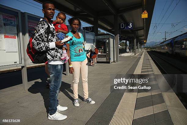 Young migrant couple from Eritrea wait for a train to Munich after they were released by police following their registration at a center for migrants...