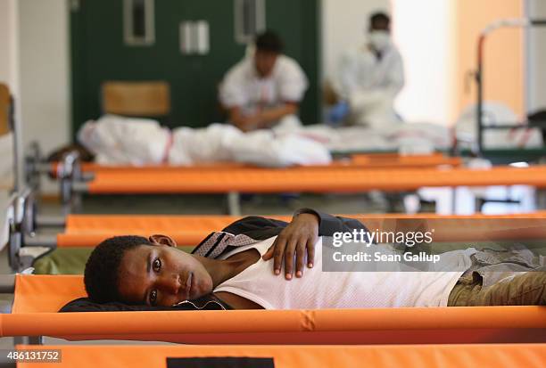 Migrant from Eritrea rests on a cot while waiting during his registration process at a center for migrants at a facility of the German Federal Police...