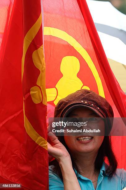 Worker's Party supporter takes shelter from the heat during nomination day at Raffles Institution on September 1, 2015 in Singapore. Nomination day...