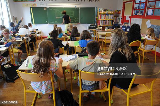 Pupils attend a classroom at the La Courbe primary school in Aytre, southwestern France on September 1 as part of the start of the new school year....