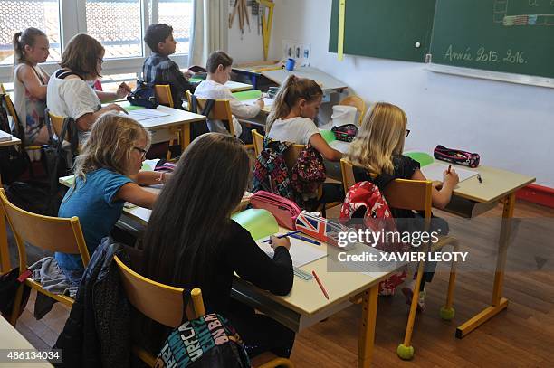 Pupils attend a classroom at the La Courbe primary school in Aytre, southwestern France on September 1 as part of the start of the new school year....