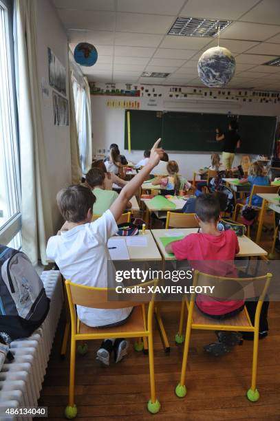 Pupils attend a classroom at the La Courbe primary school in Aytre, southwestern France on September 1 as part of the start of the new school year....