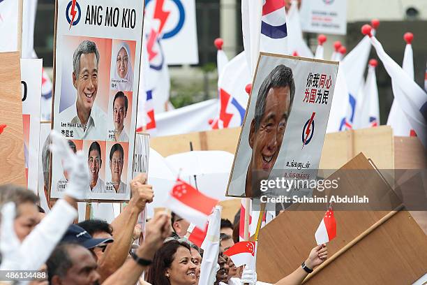 People's Action Party supporters react to their candidate speech after nomination is closed at Raffles Institution on September 1, 2015 in Singapore....