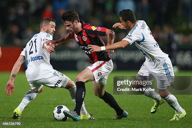 Hristijan Tanoski of the Suns takes the ball past Carl Valeri and Daniel Georgievski of the Victory during the FFA Cup Round of 16 match between...