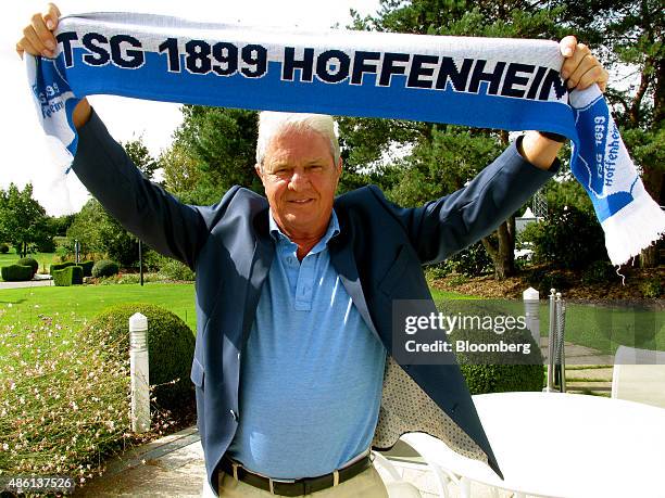 Dietmar Hopp, German billionaire and co-founder of SAP SE, poses for a photograph holding a supporters scarf for the German soccer club TSG 1988...