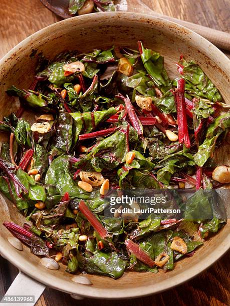 swiss chard sautéed with garlic,olive oil and pine nuts - chard stock pictures, royalty-free photos & images