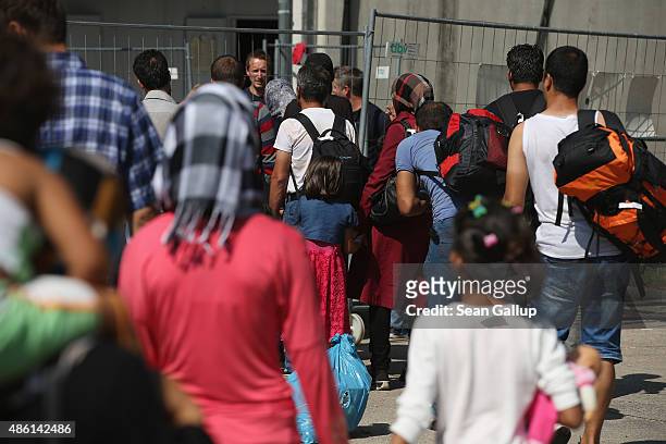 Migrants, mostly from Syria, arrive for registration at a facility of the German Federal Police on September 1, 2015 in Deggendorf, Germany. Trains...