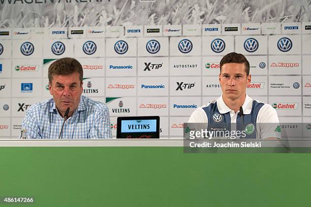 Head Coach Dieter Hecking and Julian Draxler of VfL Wolfsburg talk to the media during a press conference at Volkswagen Arena on September 1, 2015 in...