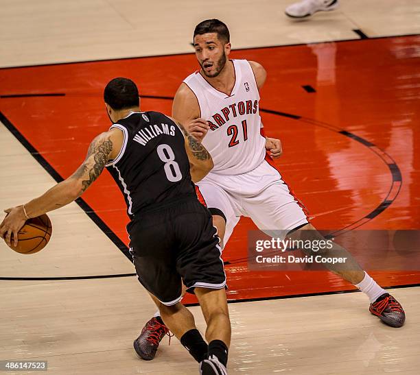 Toronto Raptors guard Greivis Vasquez tries to guard Brooklyn Nets guard Deron Williams in the Toronto end during game two between the Toronto...