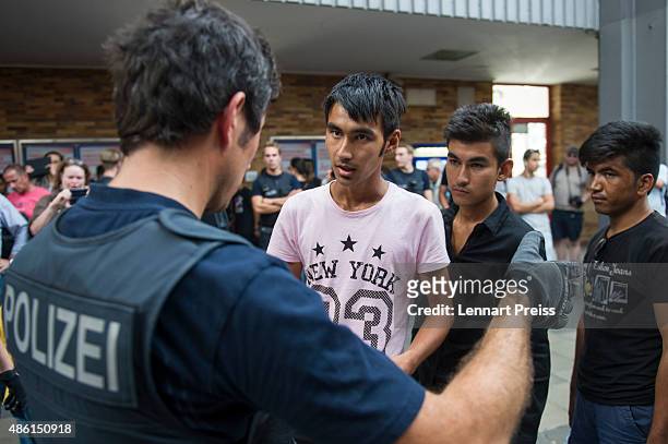 Police detain migrants who had arrived at Munich Hauptbahnhof main railway station and who had no passports or valid visas on September 1, 2015 in...