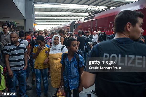 Police detain migrants who had arrived at Munich Hauptbahnhof main railway station and who had no passports or valid visas on September 1, 2015 in...