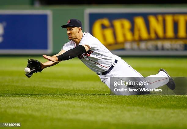 Grady Sizemore of the Boston Red Sox dives for a fly ball in right field but comes up short against the New York Yankees during the game at Fenway...