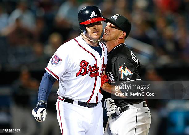 Jose Fernandez of the Miami Marlins tags out Ryan Doumit of the Atlanta Braves down the first base line after he scooped up his ground ball to end...