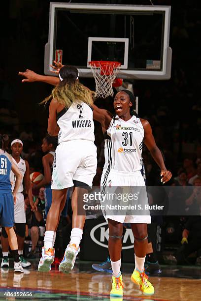 Tina Charles of the New York Liberty celebrates with Candice Wiggins during the game against the Minnesota Lynx on August 28, 2015 at Madison Square...