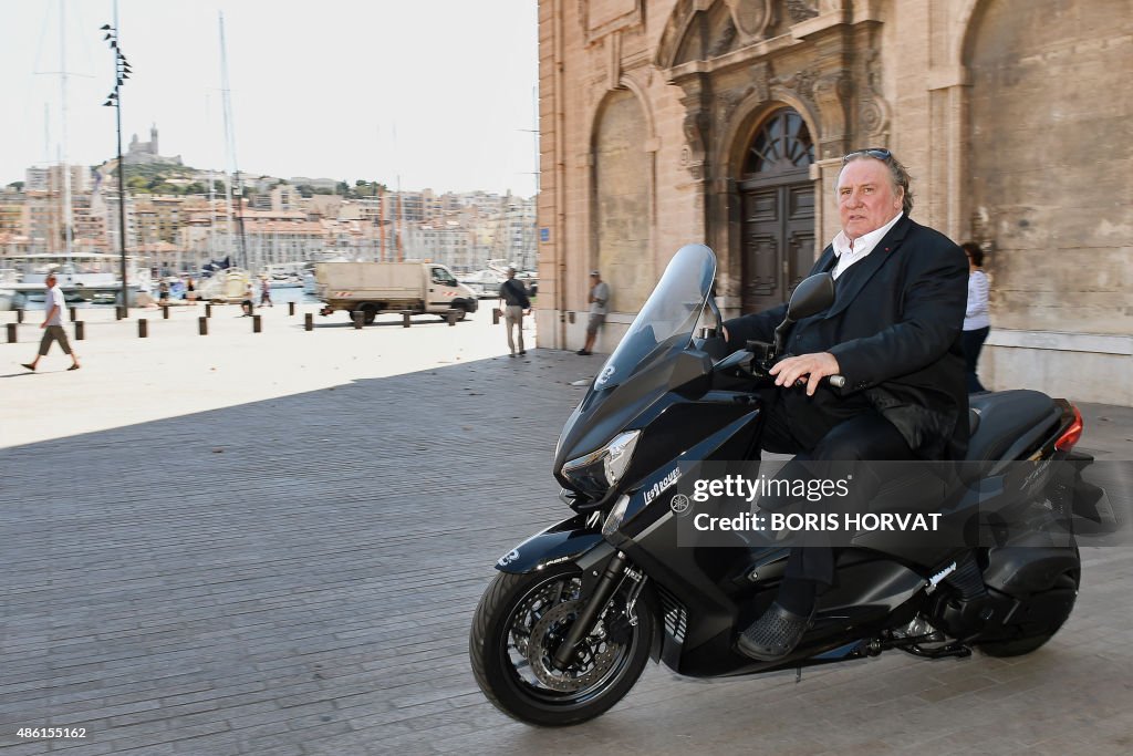 French-born actor Gerard Depardieu drives scooter at the... Photo Images