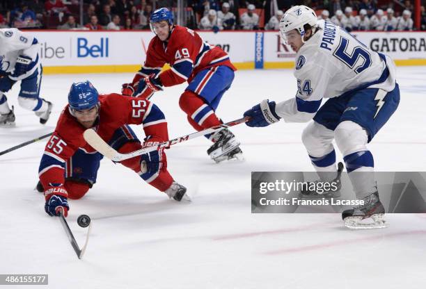 Francis Bouillon of the Montreal Canadiens fights for the puck against Cedric Paquette of the Tampa Bay Lightning in Game Four of the First Round of...