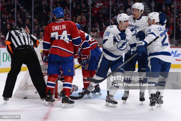 Ondrej Palat of the Tampa Bay Lightning celebrates with teammates Keith Aulie and Matthew Carle after scoring a goal on goaltender Carey Price of the...