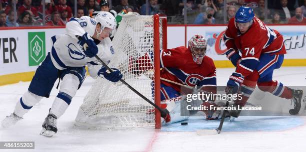 Carey Price and Alexei Emelin of the Montreal Canadiens defend the net against Ondrej Palat of the Tampa Bay Lightning in Game Four of the First...