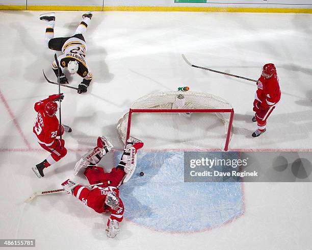 Jimmy Howard of the Detroit Red Wings lays on the ice after a Jordan Caron's of the Boston Bruins shot scores on him during Game Three of the First...