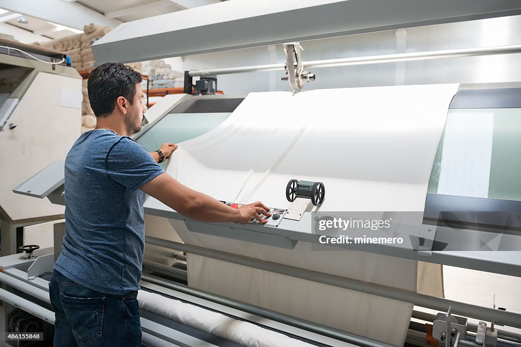 Textile quality controller checking fabrics