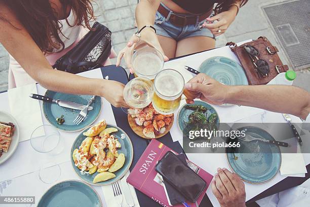 tapas and beer toast - patatas bravas bildbanksfoton och bilder