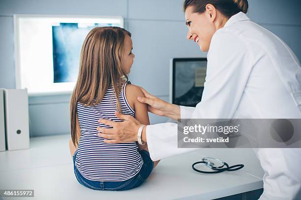 cute girl at doctor's office. - child having medical bones stock pictures, royalty-free photos & images