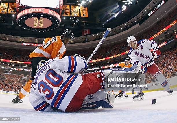 Henrik Lundqvist of the New York Rangers makes the first period save as Wayne Simmonds of the Philadelphia Flyers looks for the rebound in Game Three...