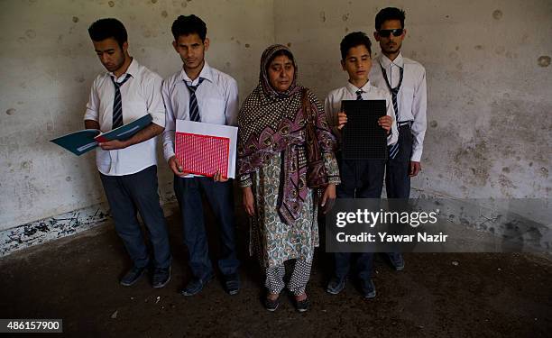 Naseema Bano, a teacher who is blind, poses with her blind students at Abhedananda Home, a school for deaf, mute and blind students on September 1,...