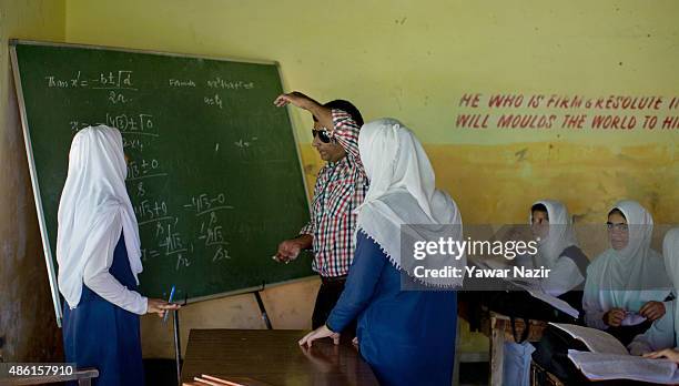 Javaid Ahmadwho, a teacher without a disability, teaches a class of deaf and mute students at Abhedananda Home, a school for deaf, mute and blind...