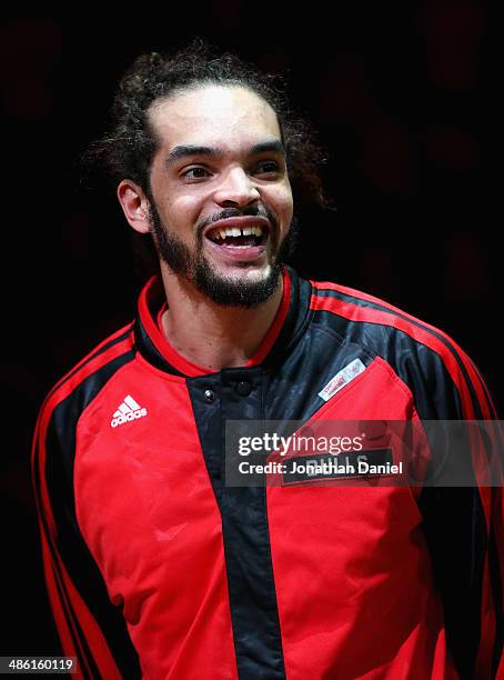 Joakim Noah of the Chicago Bulls smiles as he accepts the 2013-1014 NBA Defensive Player of the Year trophy before Game Two of the Eastern Conference...
