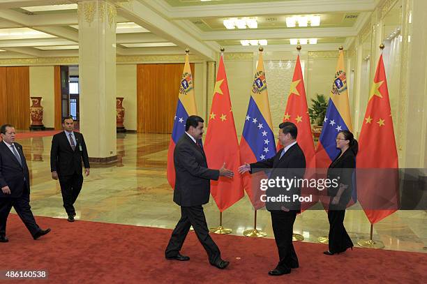 Chinese President Xi Jinping shakes hands with Venezuela's President Nicolas Maduro before their meeting at the Great Hall of the People September 1,...