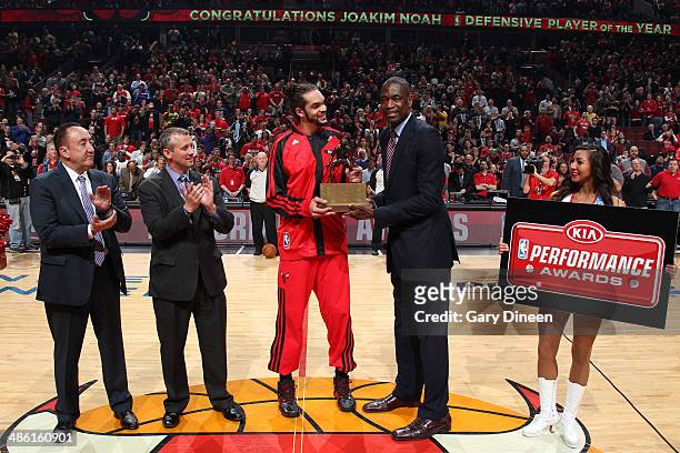 Joakim Noah of the Chicago Bulls is presented with the 2014 Kia NBA Defensive Player of the Year award from NBA Legend Dikembe Mutombo prior to the...