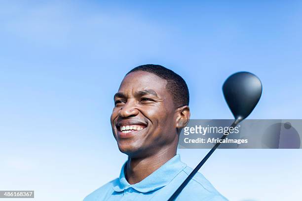 african golfer smiling with confidence, ready to play. - golf short iron stock pictures, royalty-free photos & images