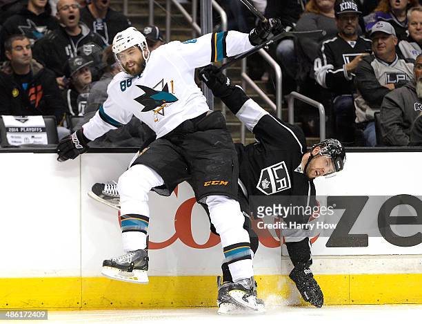 Brent Burns of the San Jose Sharks checks Jake Muzzin of the Los Angeles Kings during the first period in Game Three of the First Round of the 2014...