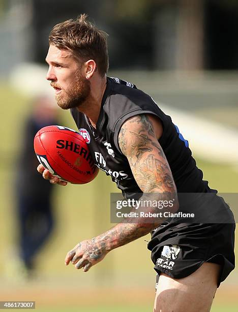 Dane Swan of the Magpies controls the ball during a Collingwood Magpies AFL training session at Olympic Park on April 23, 2014 in Melbourne,...