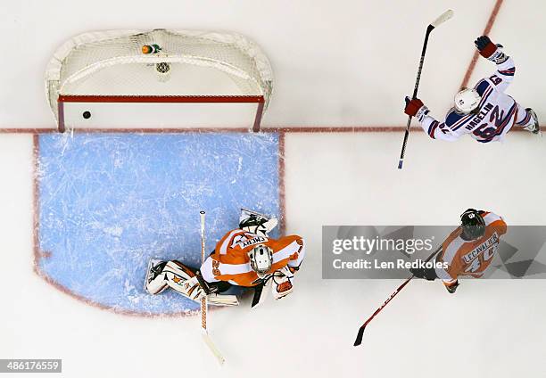 Carl Hagelin of the New York Rangers celebrates a first period goal against Ray Emery and Vincent Lecavalier of the Philadelphia Flyers in Game Three...