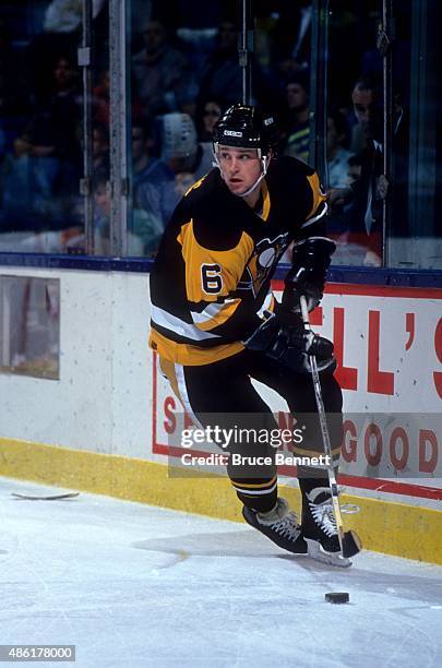 Scott Young of the Pittsburgh Penguins skates with the puck during an NHL preseason game against the New York Islanders in September 1990 at the...