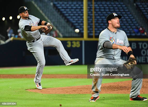Justin Bour of the Miami Marlins is unable to make a diving catch on a bunt attempt by Sugar Ray Marimon during the third inning but Martin Prado was...
