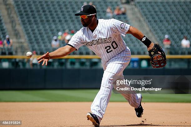 First baseman Wilin Rosario of the Colorado Rockies fields a ground ball and earns an assist against the Arizona Diamondbacks at Coors Field on...