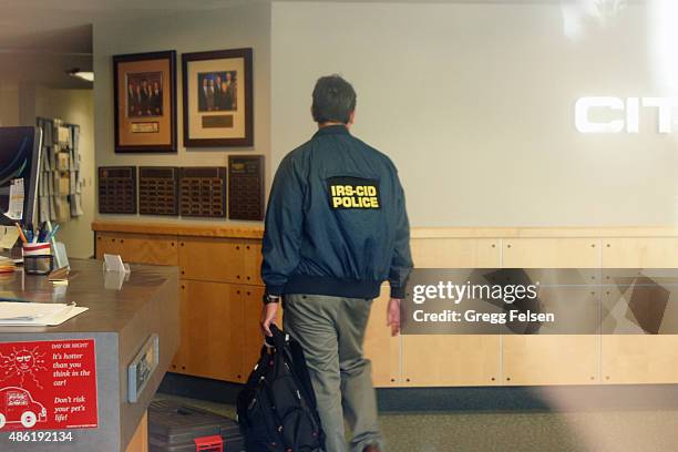 An agent from the Internal Revenue Service Criminal Investigation Division works inside Palm Springs City Hall lobby on September 1, 2015 in Palm...