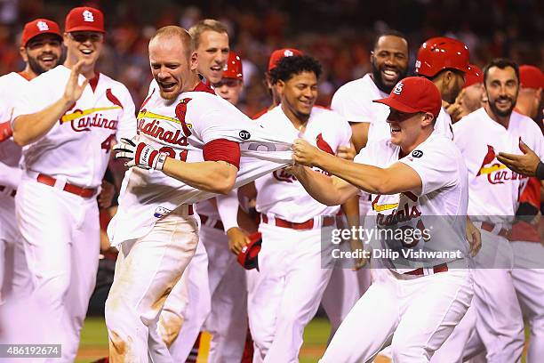 Seth Maness of the St. Louis Cardinals celebrates with Brandon Moss of the St. Louis Cardinals after Moss hit a walk-off solo home run against the...