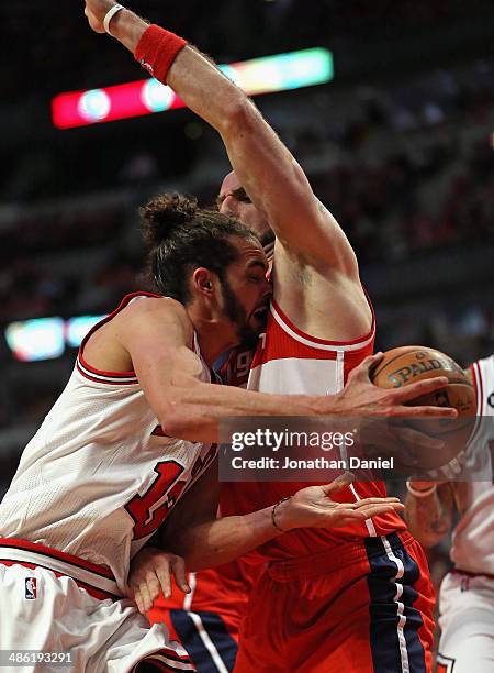 Joakim Noah of the Chicago Bulls runs into Marcin Gortat of the Washington Wizards in Game Two of the Eastern Conference Quarterfinals during the...