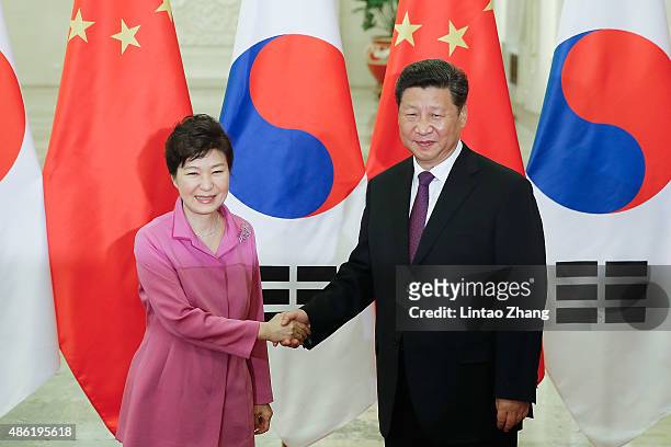 Chinese President Xi Jinping shankes hands with South Korean President Park Geun-hye at The Great Hall Of The People on September 2, 2015 in Beijing,...