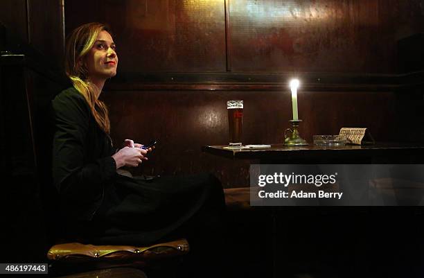 Woman speaks to the bartender, unseen, while having a beer at the Alt Berlin bar on April 22, 2014 in Berlin, Germany. The bar, which opened in 1893...