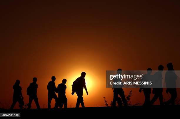 Syrian refugees and migrants along a railway line as they try to cross from Serbia into Hungary near Horgos on September 1, 2015. European Union...