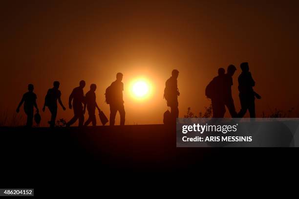 Syrian refugees and migrants along a railway line as they try to cross from Serbia into Hungary near Horgos on September 1, 2015. European Union...