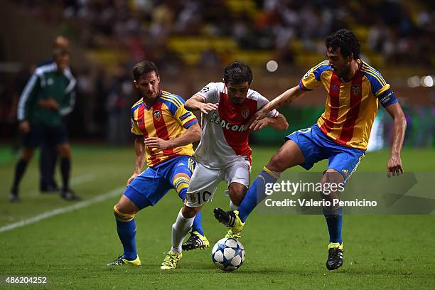 Bernardo Silva of Monaco is challenged by Daniel Parejo and Pablo Piatti of Valencia during the UEFA Champions League qualifying round play off...