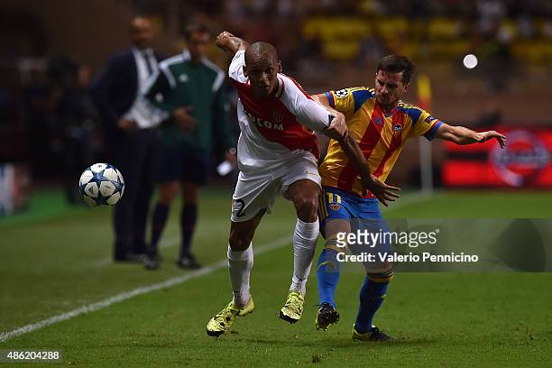 Fabinho of Monaco competes with Pablo Piatti of Valencia during the UEFA Champions League qualifying round play off second leg match between Monaco...